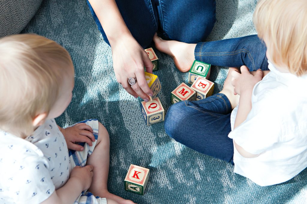 custody children learning blocks blue jeans mother parent parents